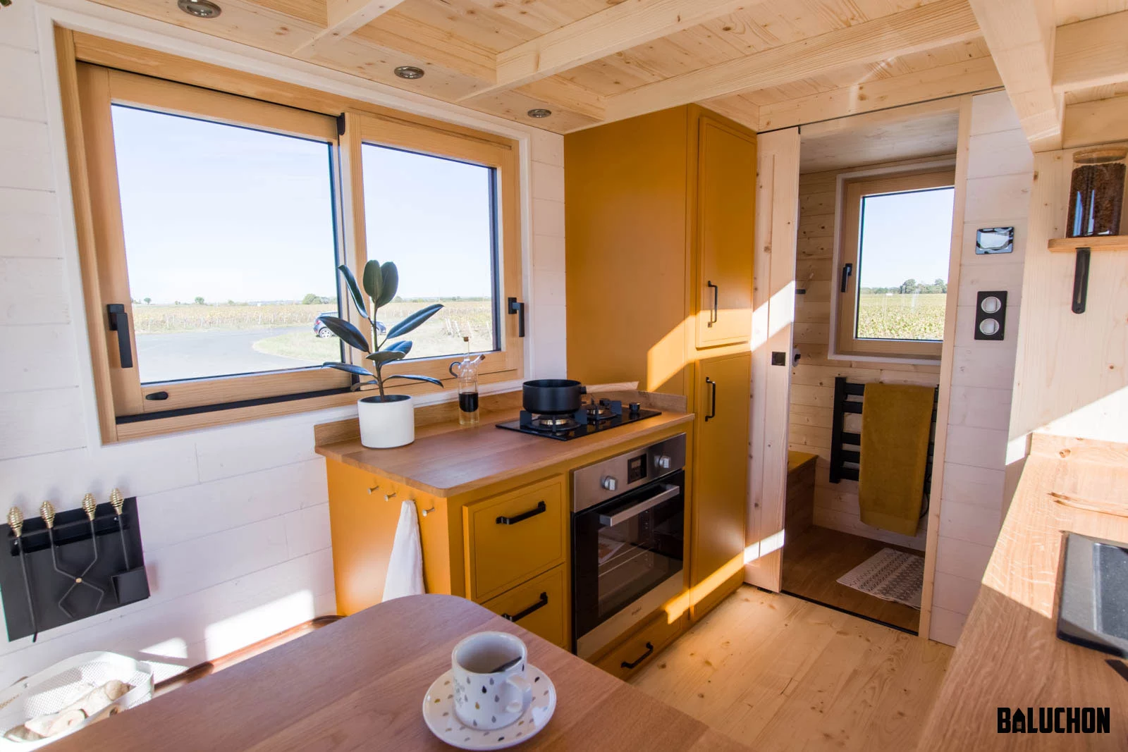 The Golden Hour's kitchen includes an oven, a two-burner propane-powered stove, and quite a lot of cabinetry