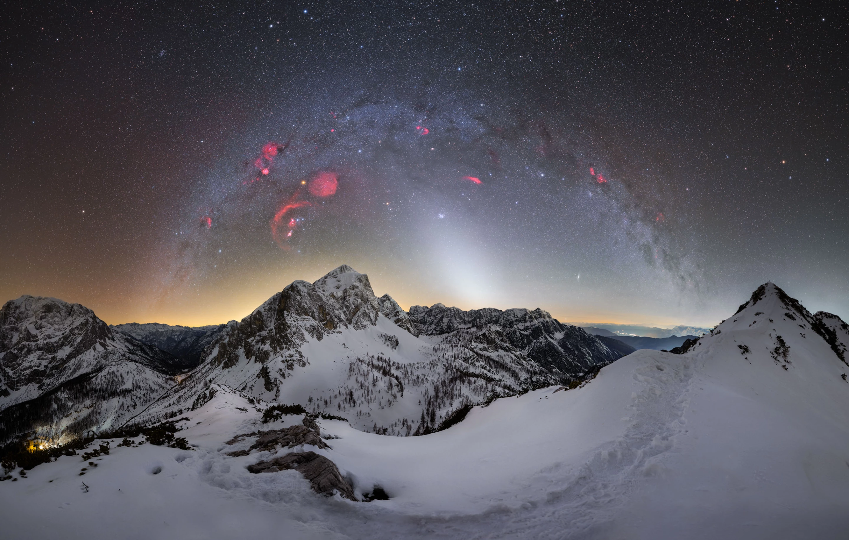 Caradhras – Milky way arch above Vrsic pass by Matej Mlakar, shot in Slovenia. Eerie red glows in the gal