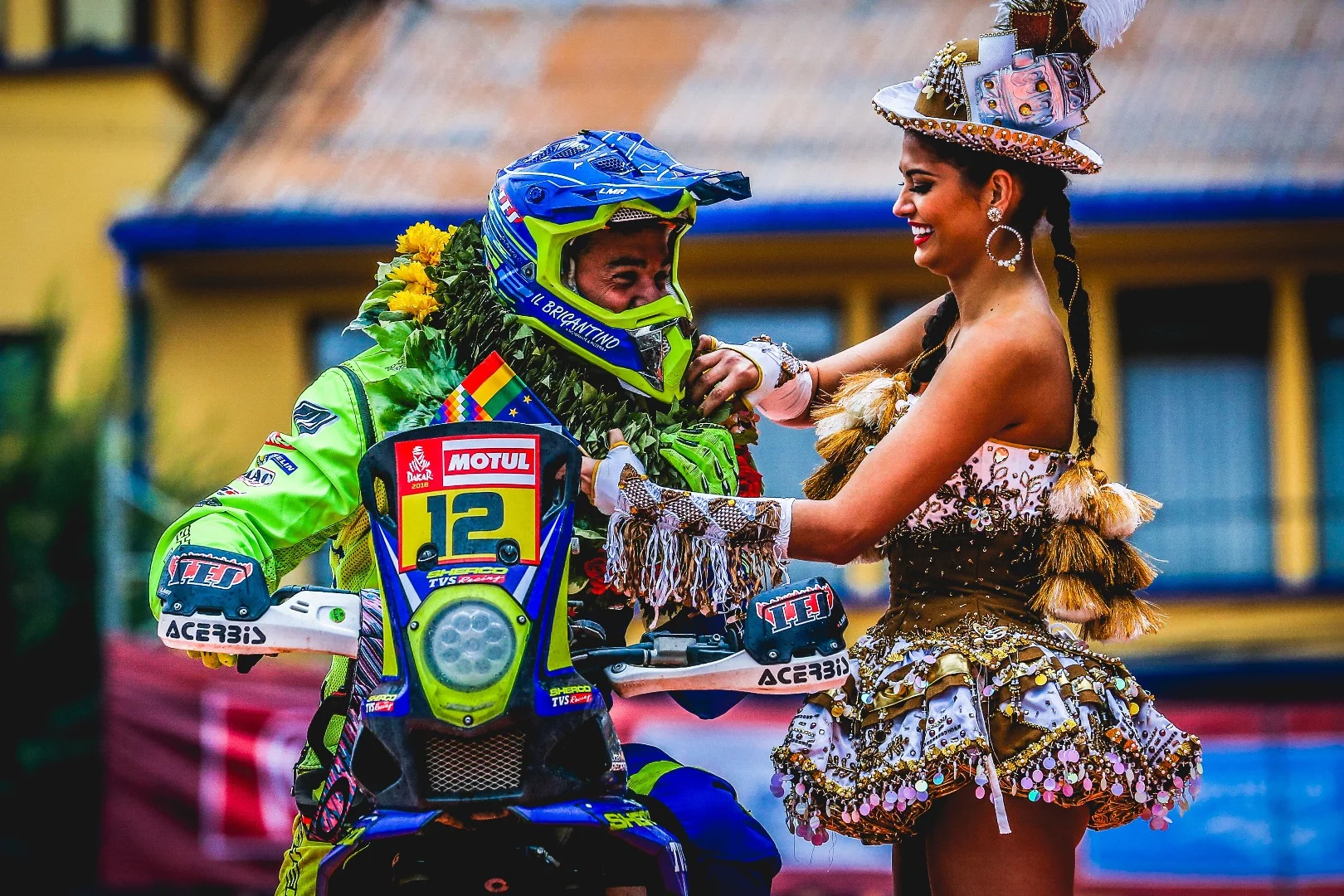 A sight for very sore eyes as a Bolivian woman welcomes Sherco's Garcia Juan Pedrero