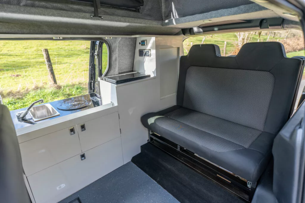The Dvan Buzz features a simple, classic floor plan with slide-and-drop bed, indoor/outdoor kitchen and as much storage as TC could carve out
