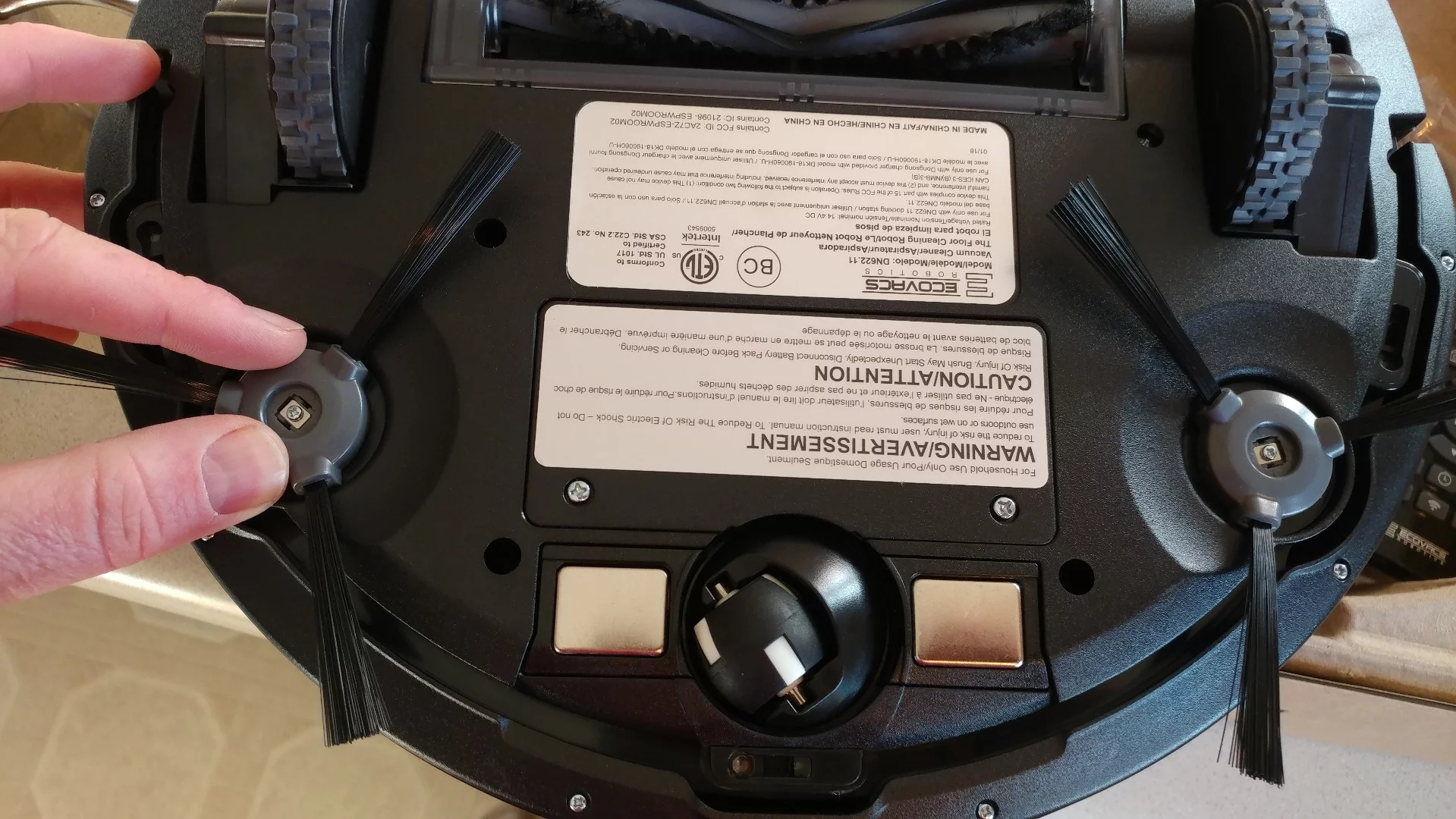 One of the first assembly steps for the Deebot N79S is to snap on the spinning brushes, which just push into place and "click"