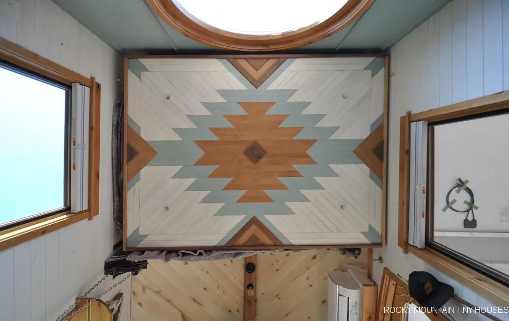 The San Juan Tiny House's elevating bed sports a decorative mosaic finish