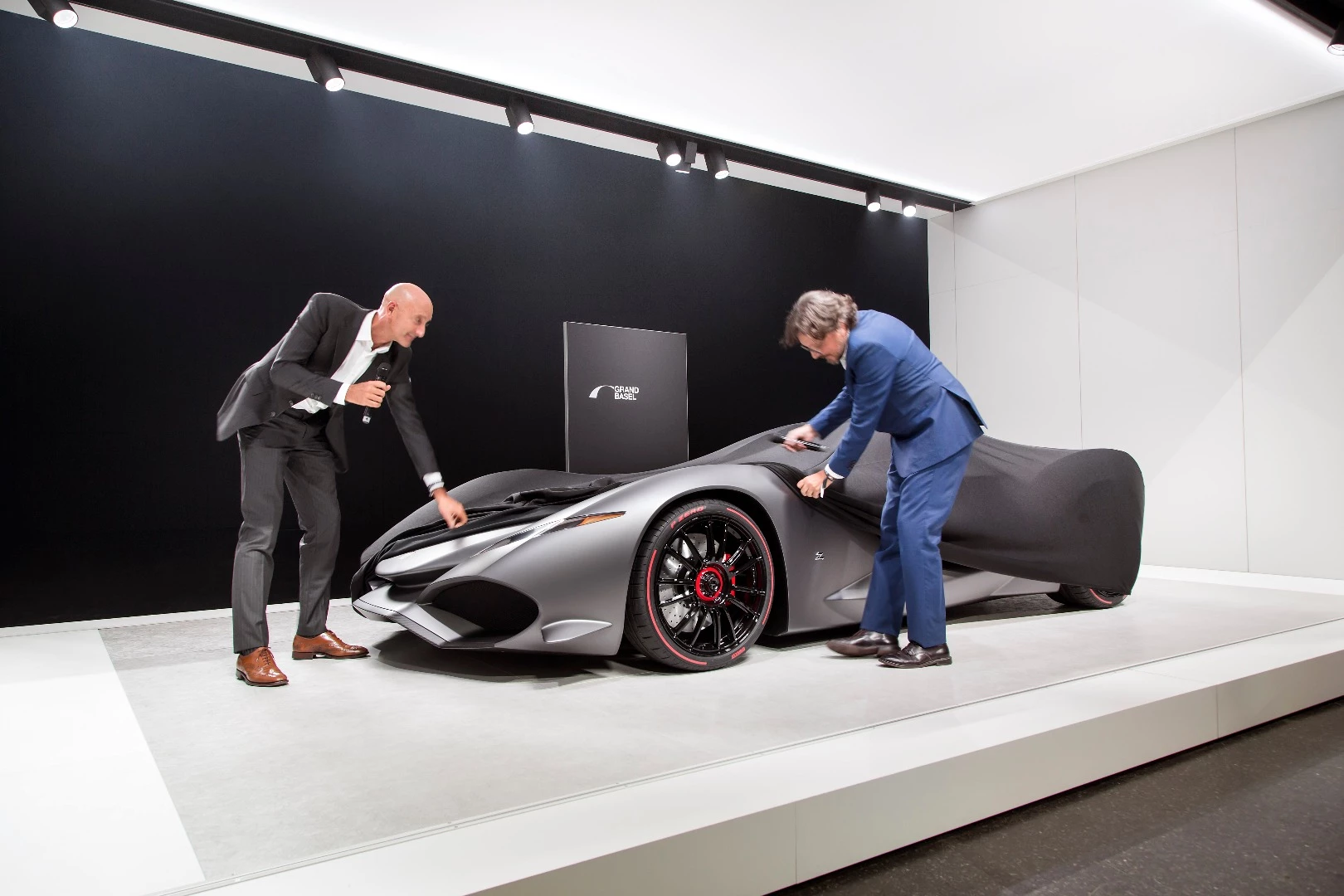 Andrea Zagato takes the covers off his Zagato IsoRivolta Vision Grand Turismo Concept. The covers were only partially removed, with the full reveal planned for October of this year (2017) when it will be available digitally as part of the Sony Playstation game series, Gran Turismo Sport. The concept is expected to be presented in full at Grand Basel 2018. He was assisted in removing the covers by Paolo Tumminelli, who will chair the Grand Basel Advisory Board.