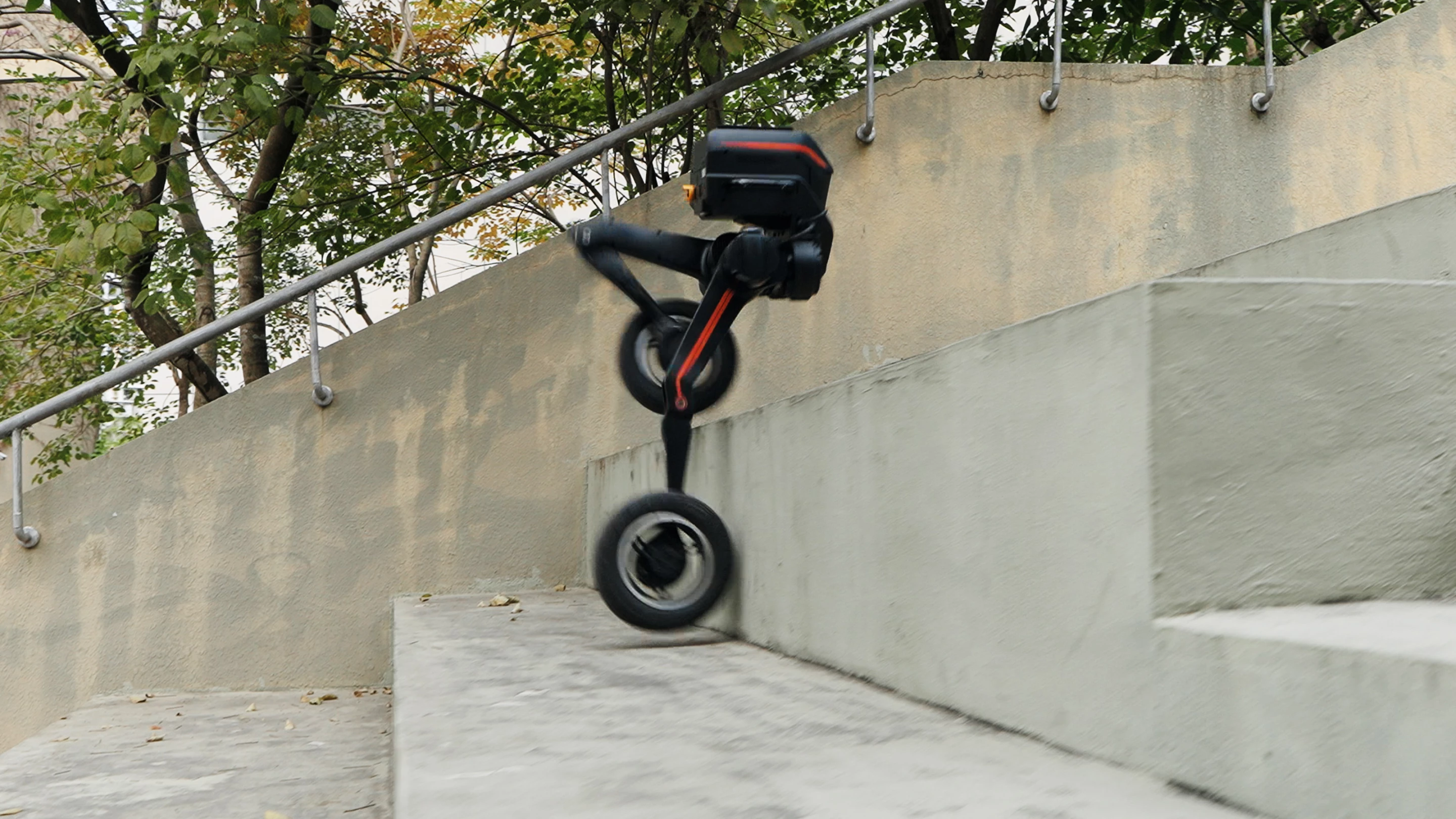 The Tron 1's motorized wheels can be locked for walk mode or for grip, while the jointed legs can be lifted to tackle obstackle