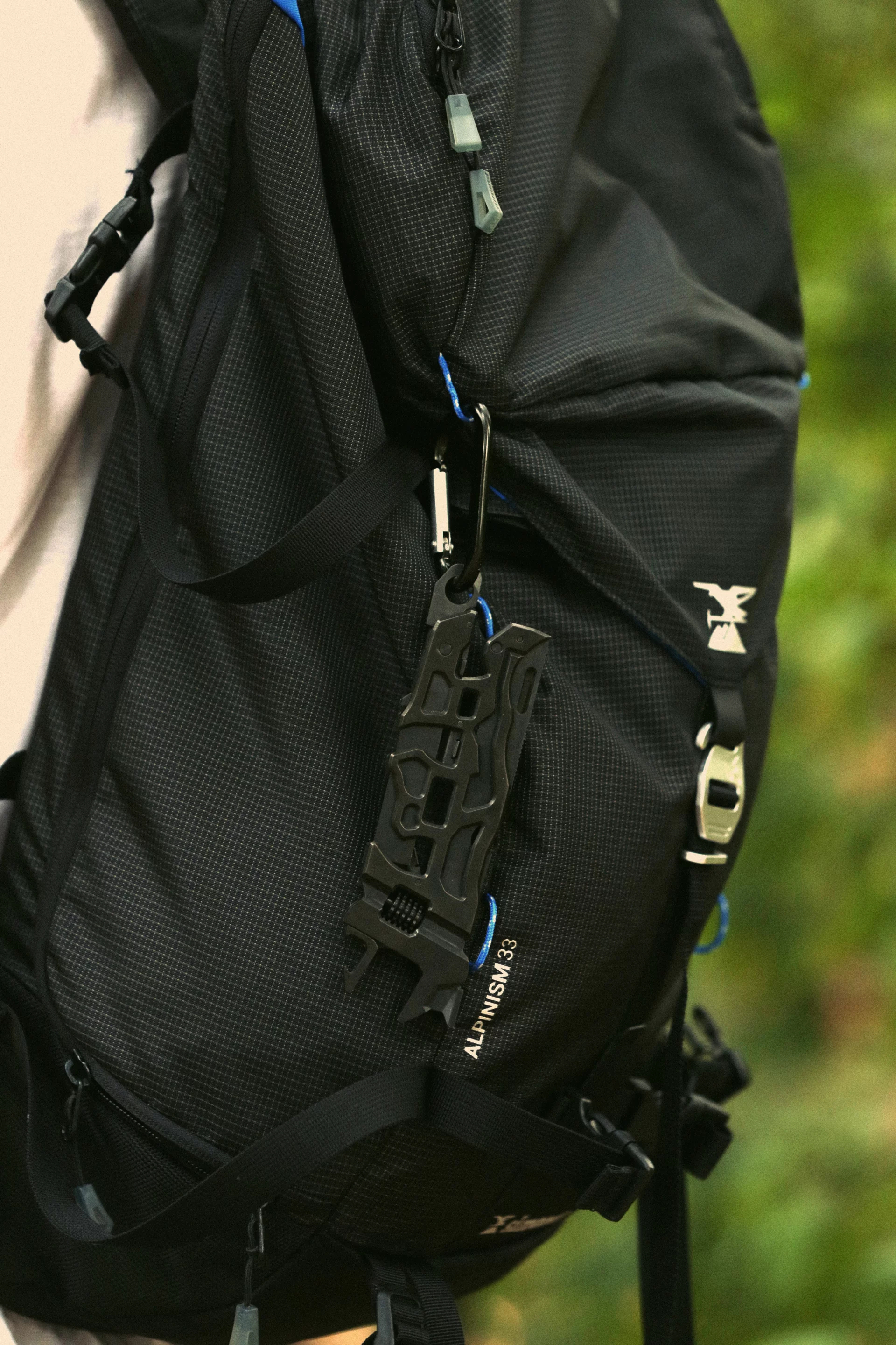 Caliber X strapped to a backpack