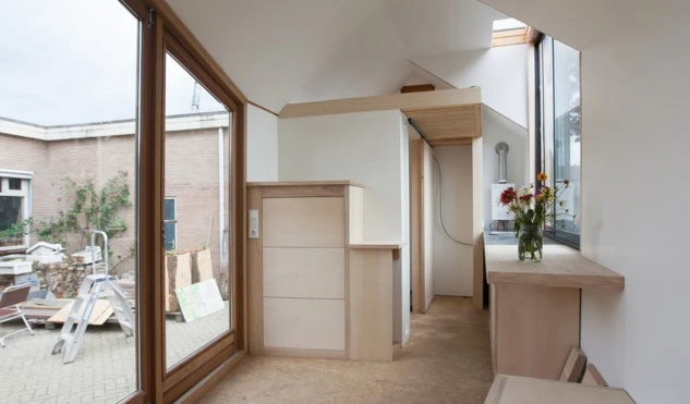 If you're wondering how to access the elevated sleeping area, the stairs towards the bed are actually disguised as a cabinet, with a movable side-table that functions as the first step
