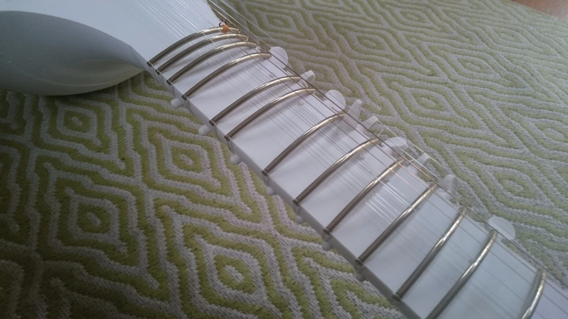 19 printed tuning pegs (or kunti) are placed at appropriate points along the head and neck