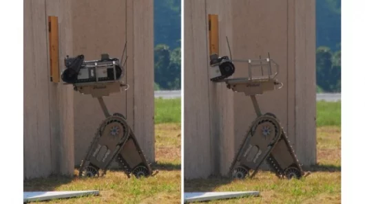The iRobot Warrior 700 raising and inserting a PackBot through a window (Credit: BotJunkie)