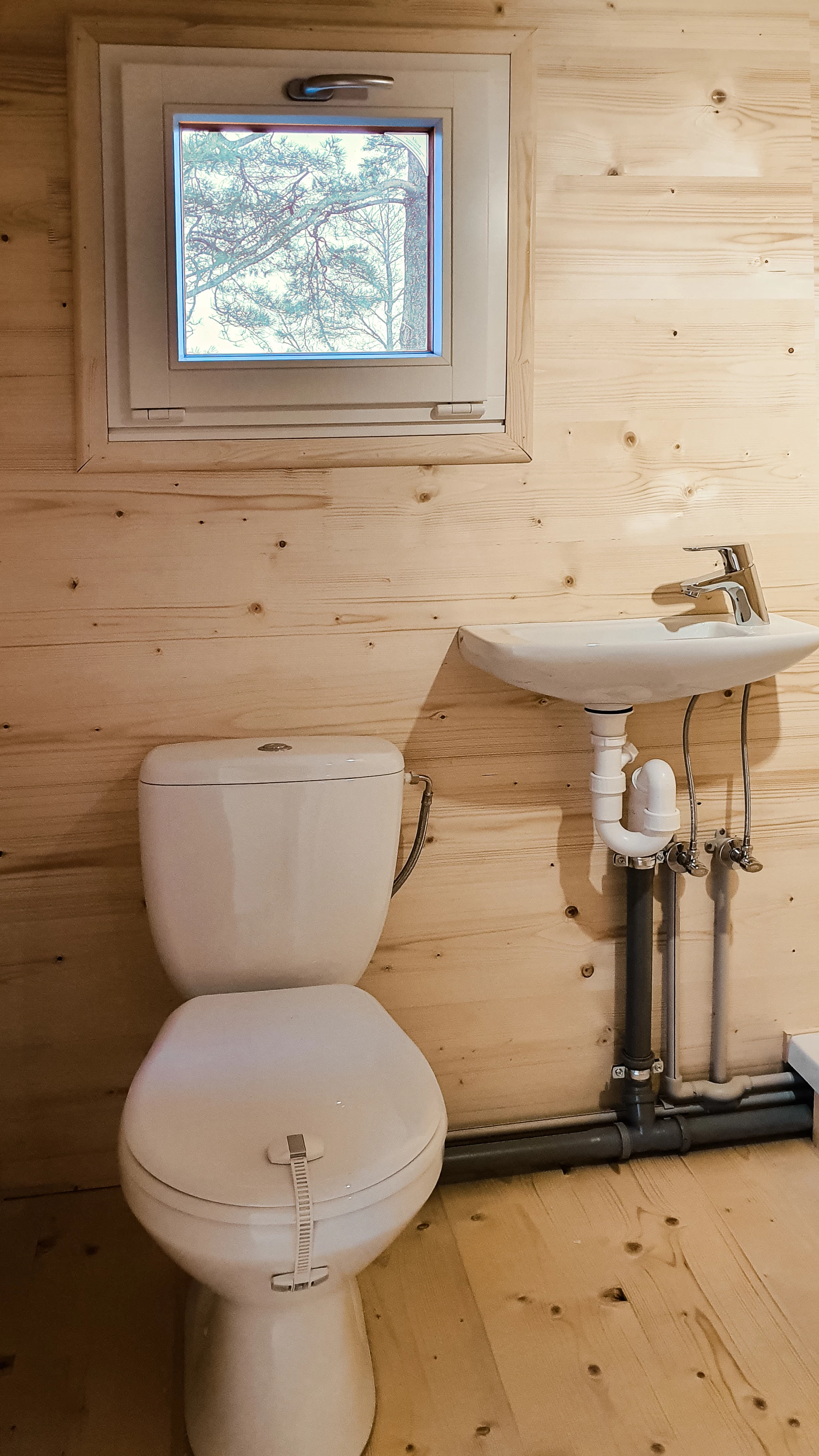 The Brette Haus includes a small bathroom with toilet, shower, and sink