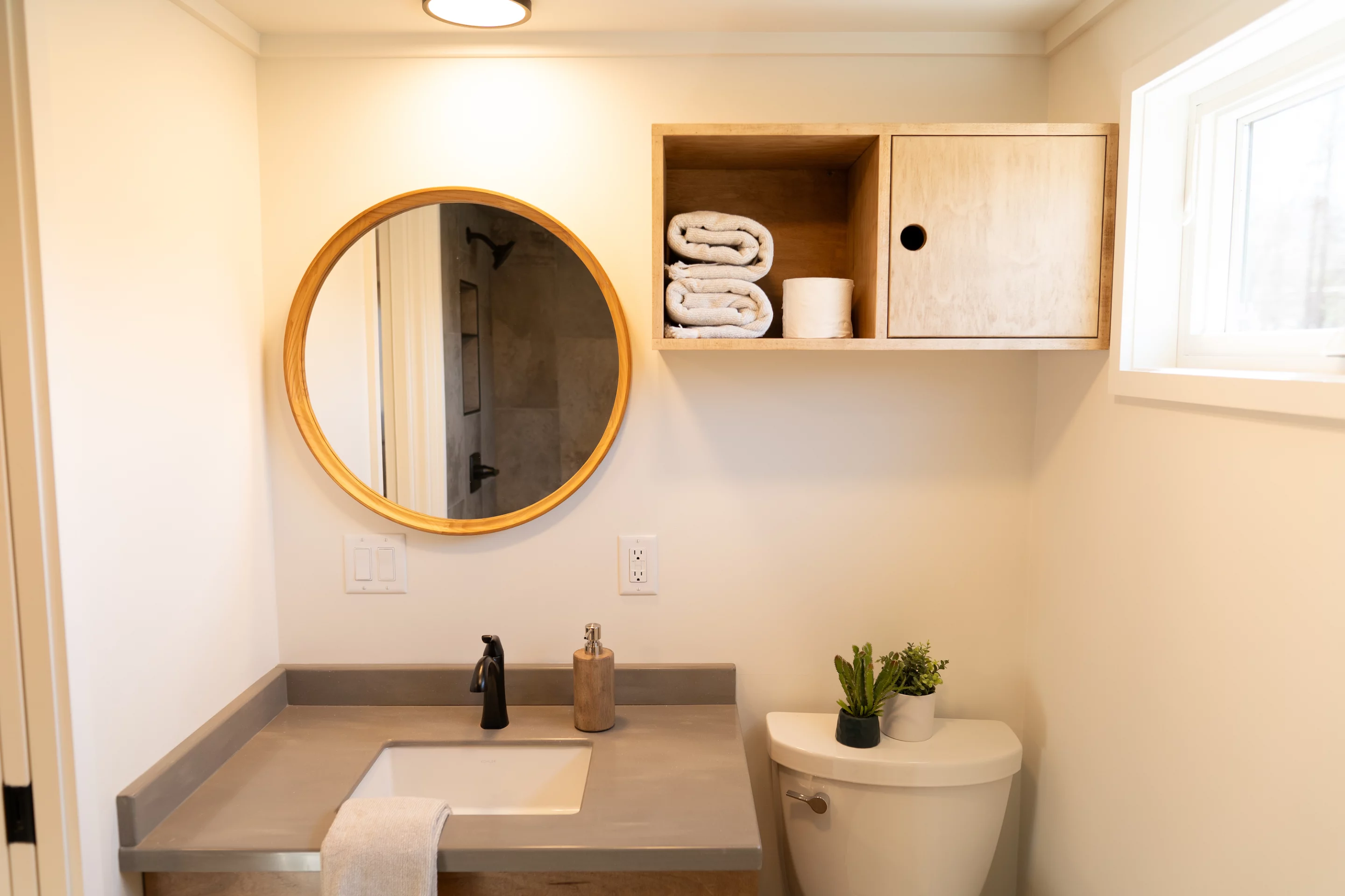 The Pisgah Park Model's bathroom includes a shower, sink, and toilet