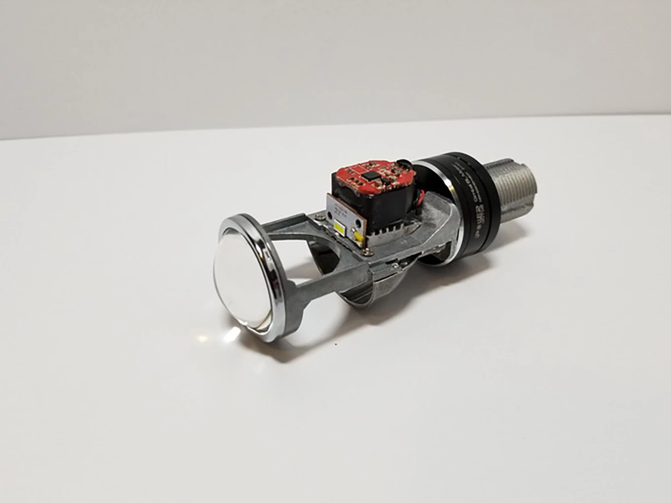 This tiny aftermarket headlight globe replacement turns your motorcycle headlight into a self-leveling projector beam