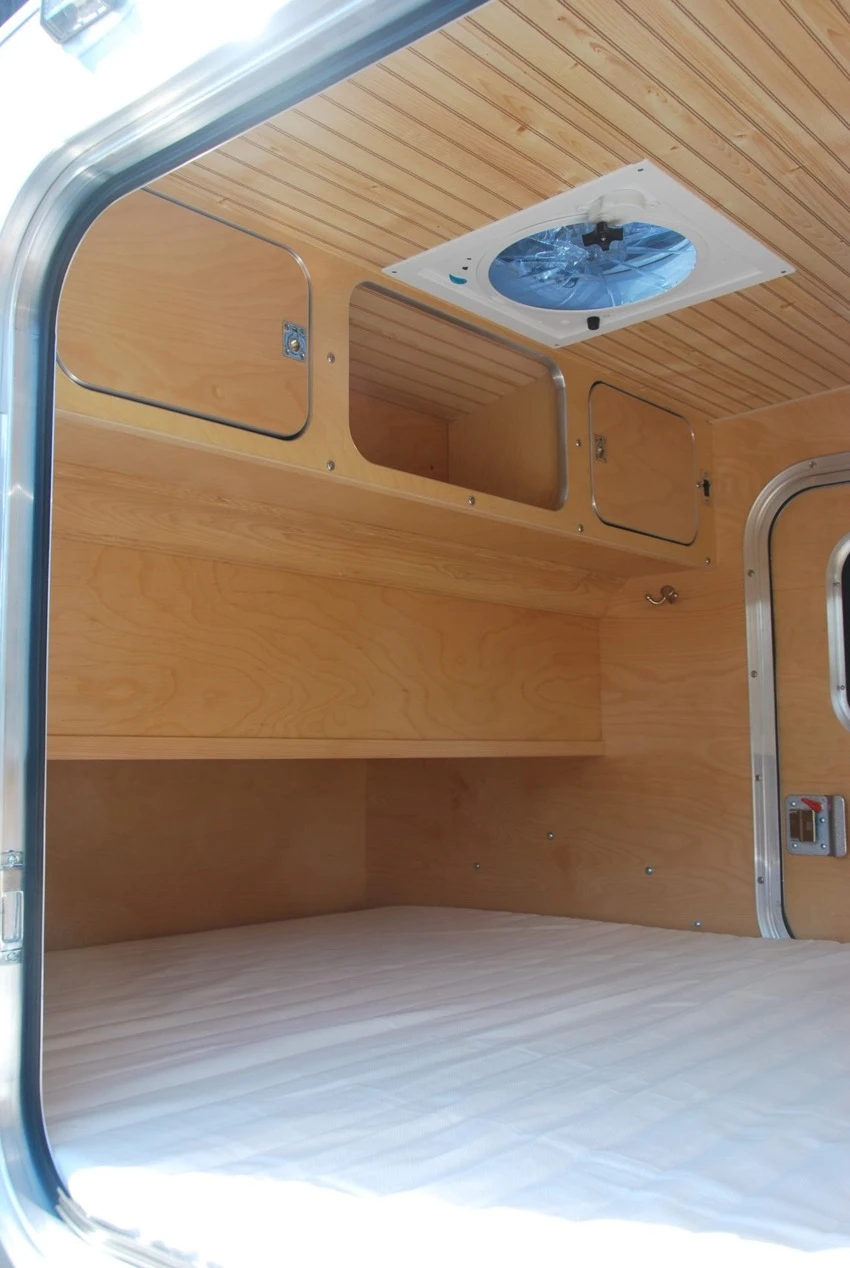 Upper storage cabinets at the foot of the bed