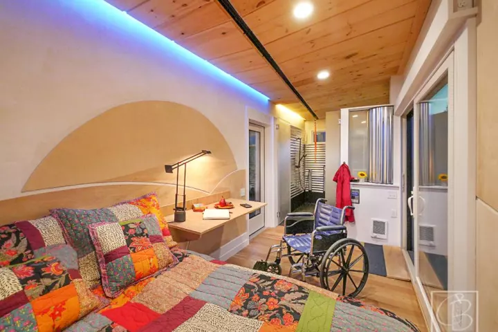 The Wheel Pad's interior layout is divided between a main living area with a bed to one side and a bathroom