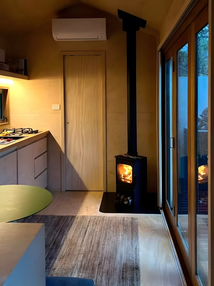 The Zinc Studio Cabin maintains a comfortable temperature with a wood-burning stove, as well as a mini-split air-conditioning unit