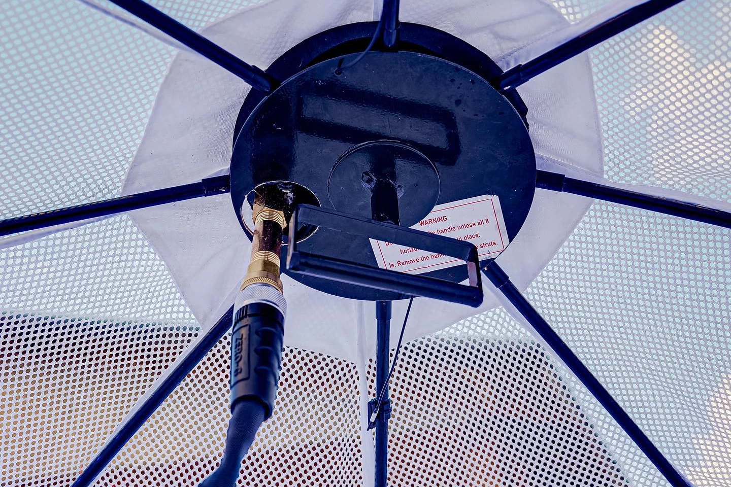 The user's garden hose goes into a receptacle in the Iglu's ceiling