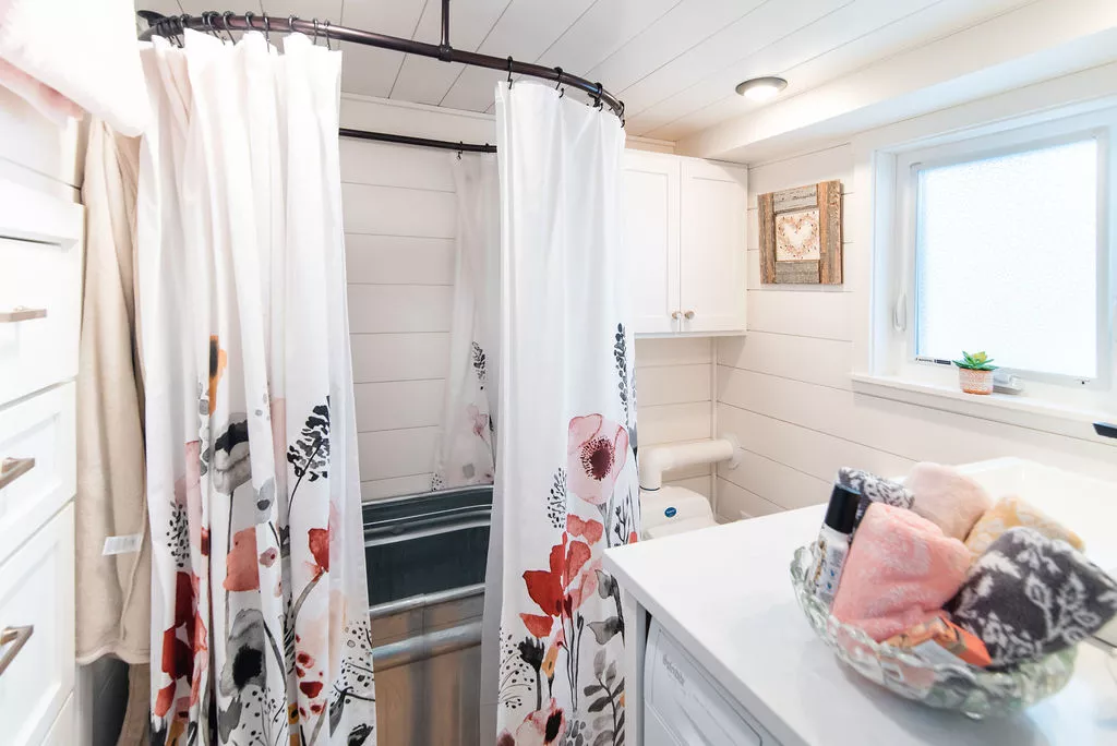 The bathroom in Jen's 34' x 10' Tiny Home includes a soaking tub