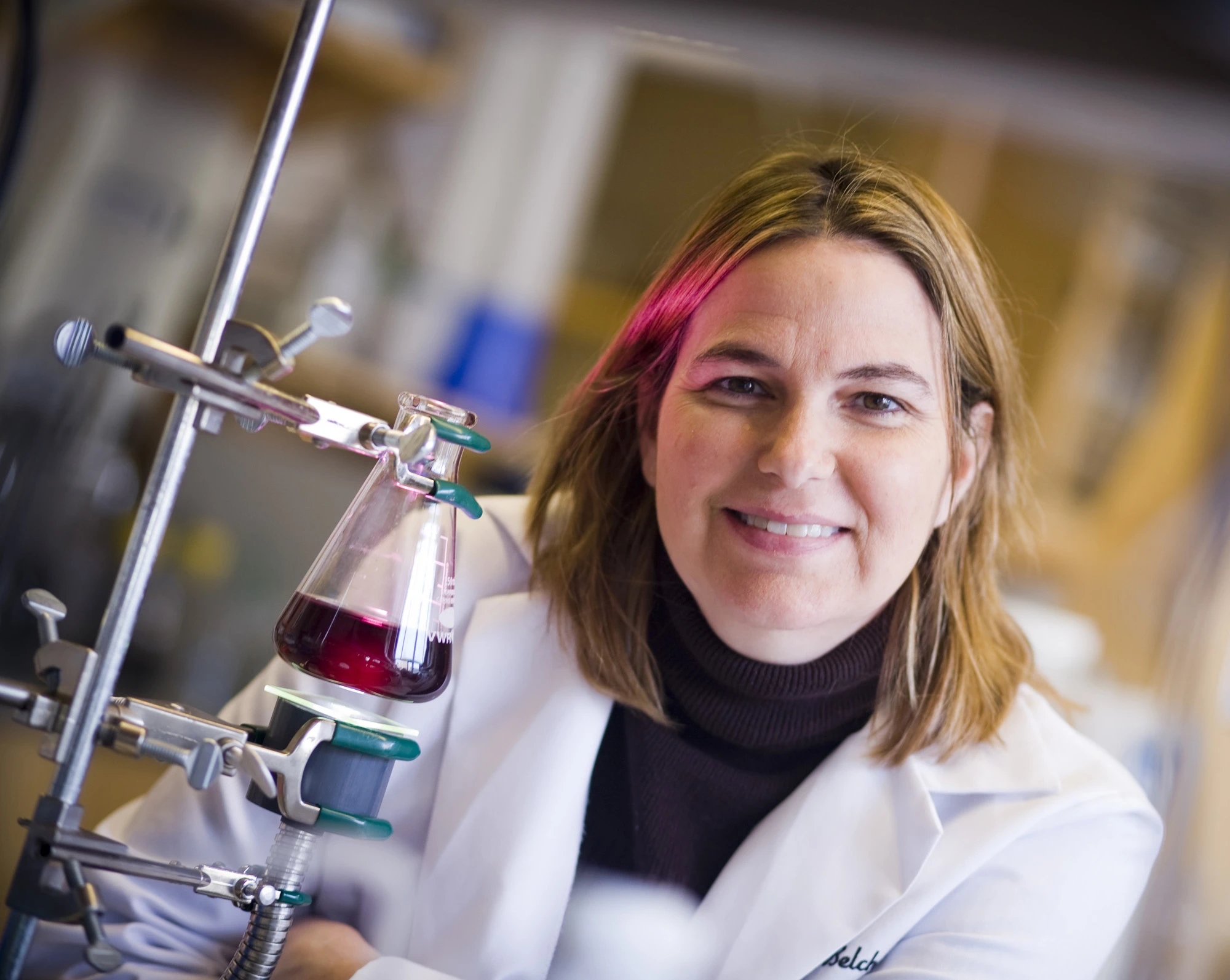 Angela Belcher, the Germeshausen Professor of Materials Science and Engineering and Biological Engineering, demonstrates a virus-templated catalyst solution used in harnessing energy from water. (Photo: Dominick Reuter)