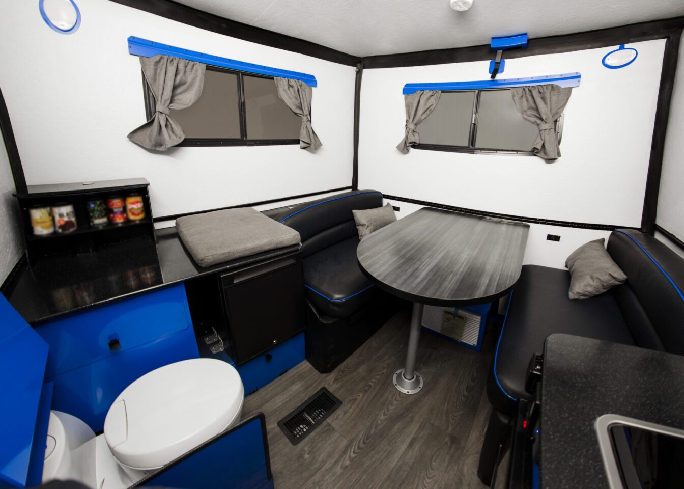 The driver side cabinet includes a pop-up pantry and fridge