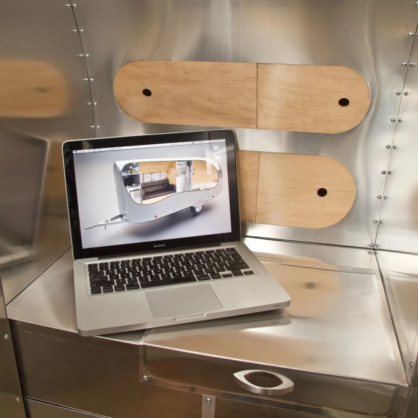Next to the sofa is a charging station for laptops, tablets and cellular devices