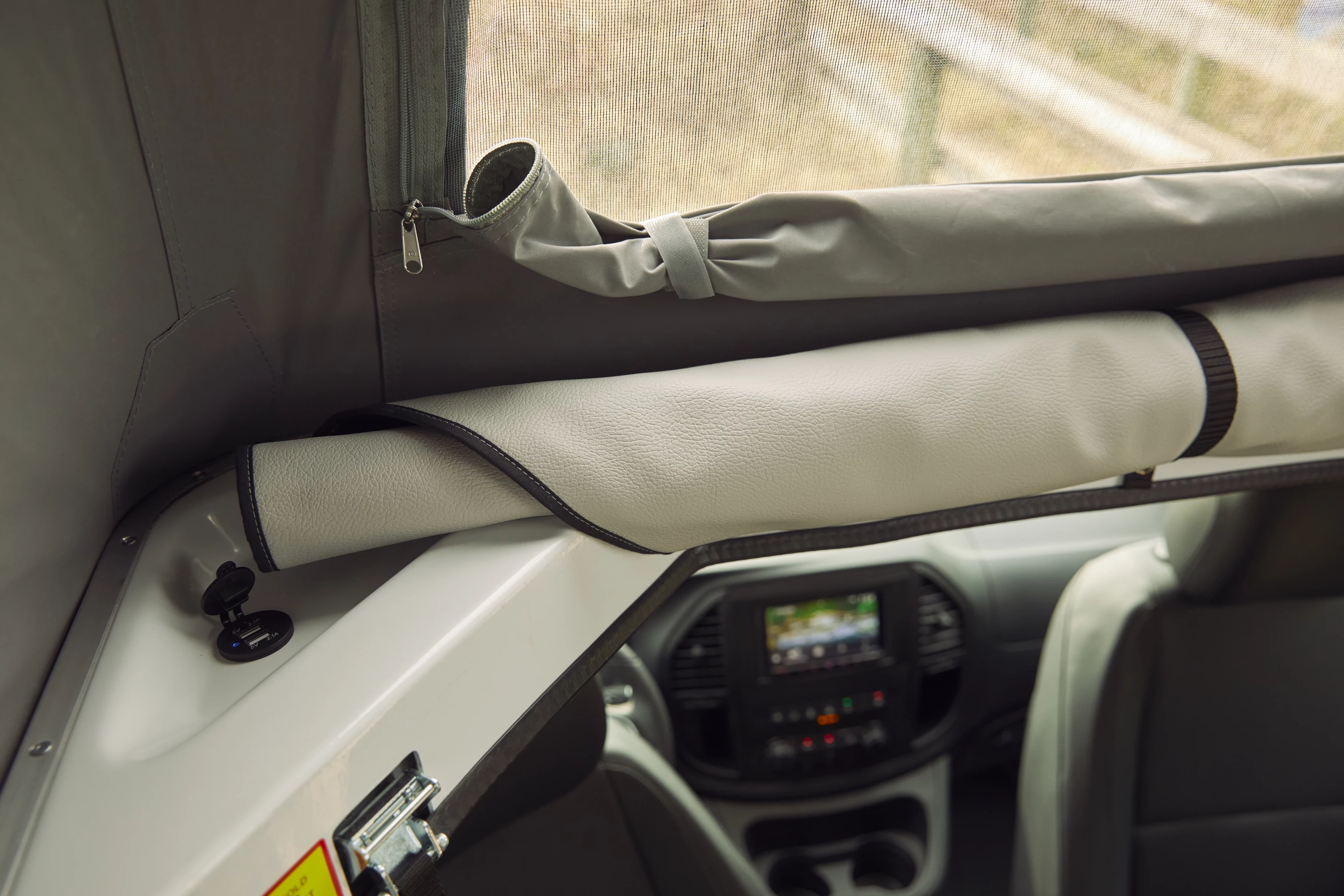 The standard-issue sleeper roof includes a spring-supported foam mattress, three windows and USB charging
