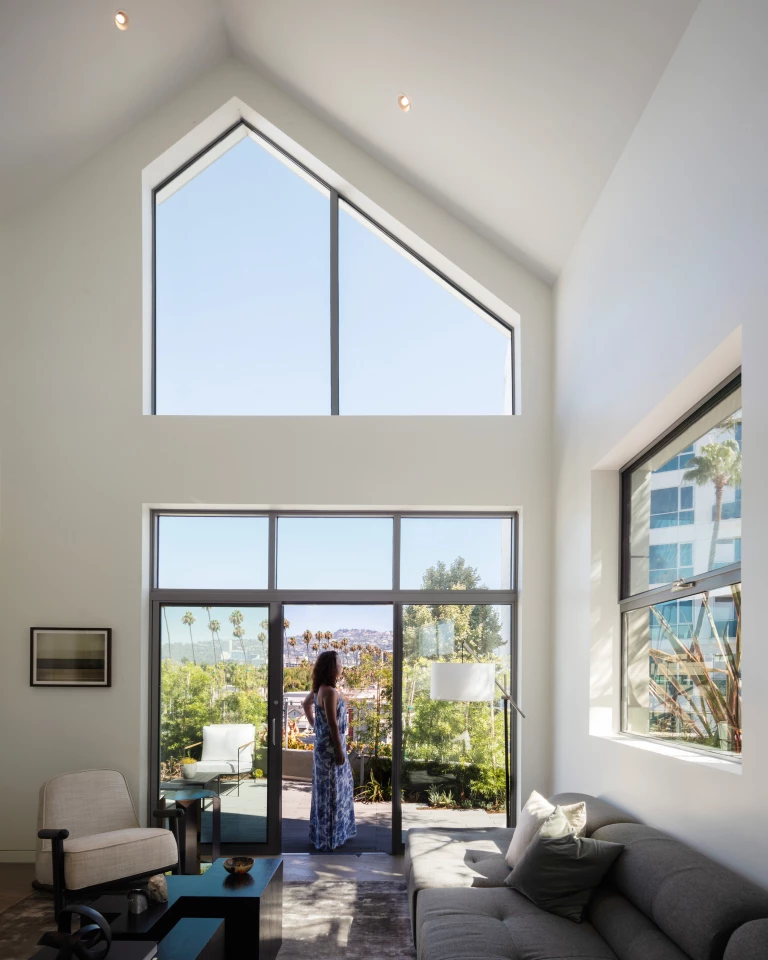 Gardenhouse's interiors are light-filled and feature white walls and stone and wooden floors