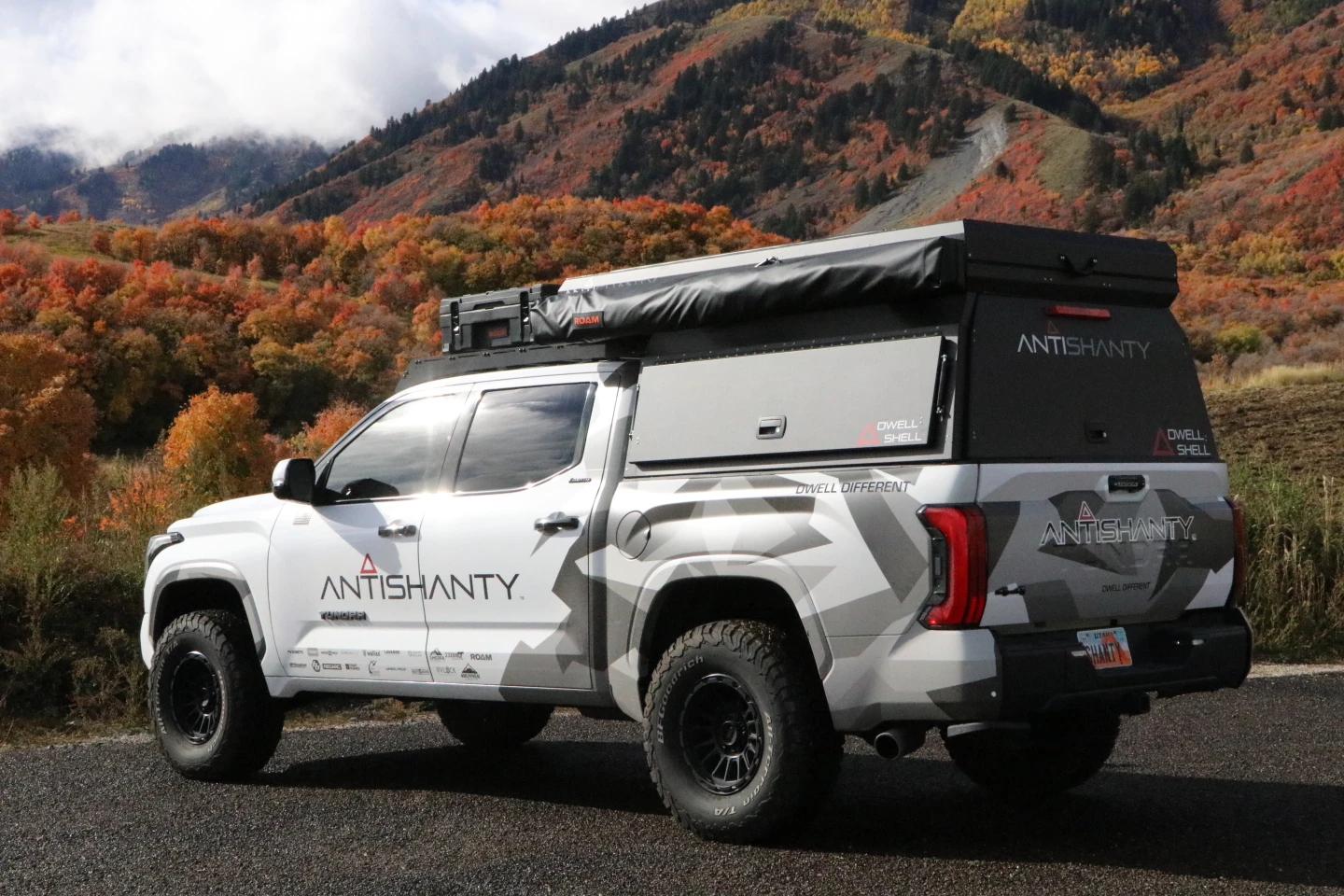 Hard-sided pickup camper hauls gear like a truck, camps like a cabin