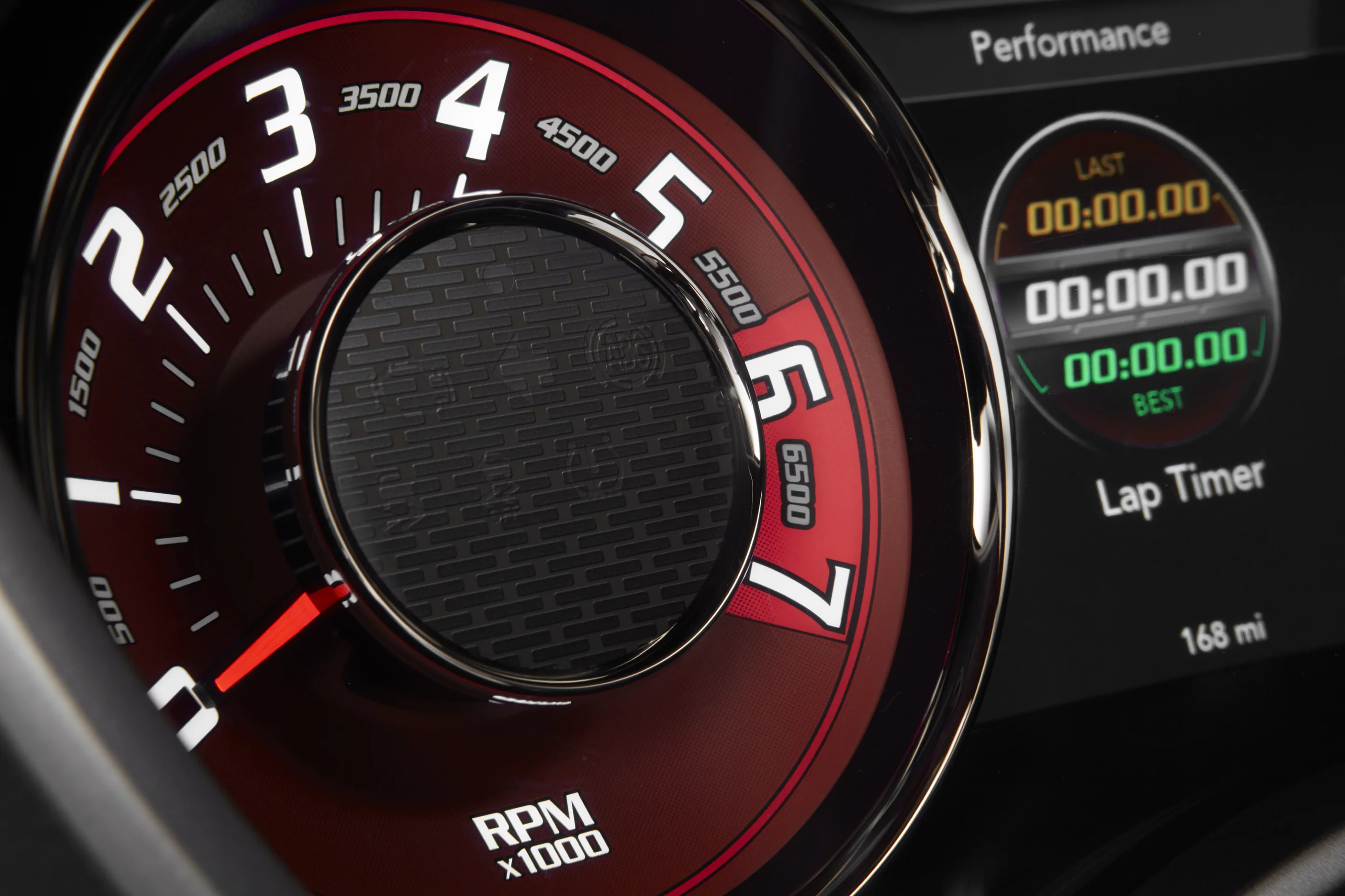 The Hellcat's fixed gauges and digital graphics are finished in "Dark Radar Red"