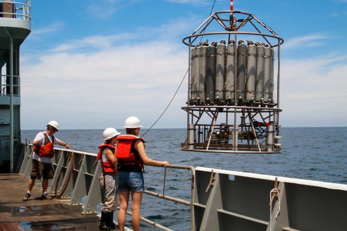 Researchers pictured with one of the sampling devices used to collect readings of the Pacific Ocean