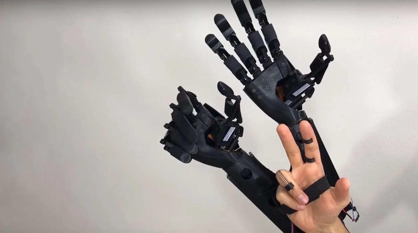 Six Actuonix actuators on each linked hand run through open and close sequences when a user moves a finger