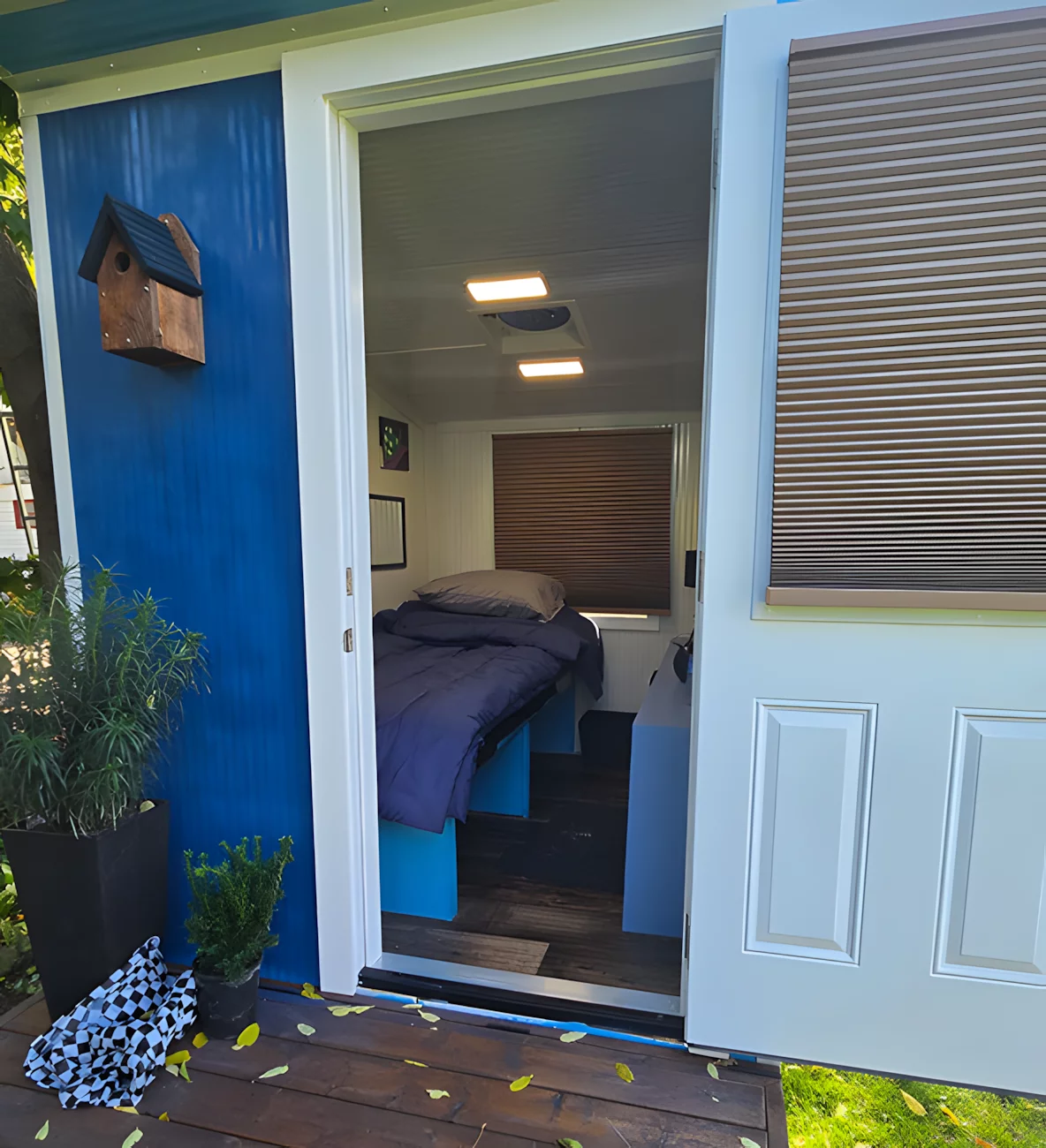 The tiny house's interior consists of a single multipurpose room with space for sleeping and storage