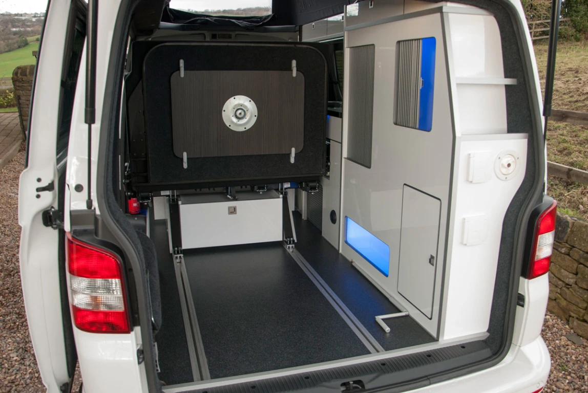 The rear seat of the Volksleisure camper slides forward to open up cargo space