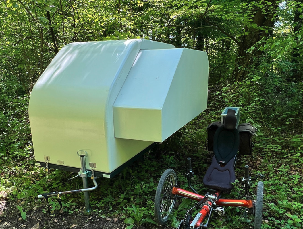 Tiny bike camper expands via slide-out to sleep 2 people + toilet