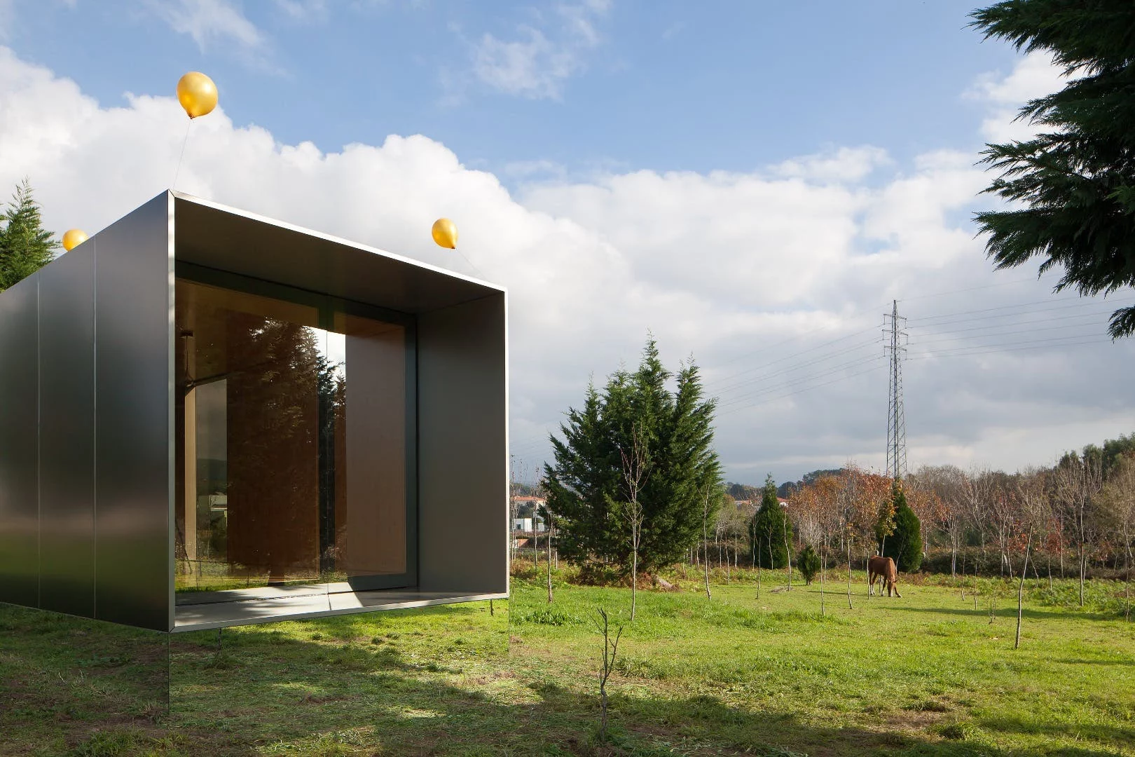 Portuguese prefabricated housing firm Mima Housing's Mima Light features a mirrored base section that makes it appear to float in mid-air