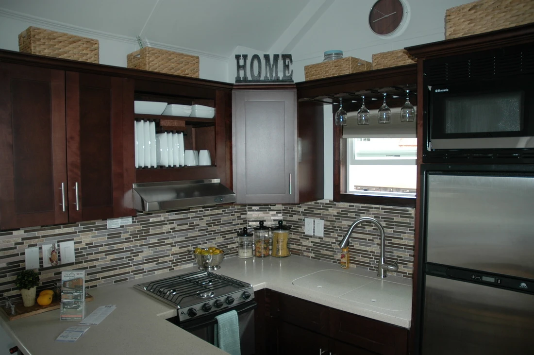 The kitchen also includes a refrigerator that operates off propane and electric