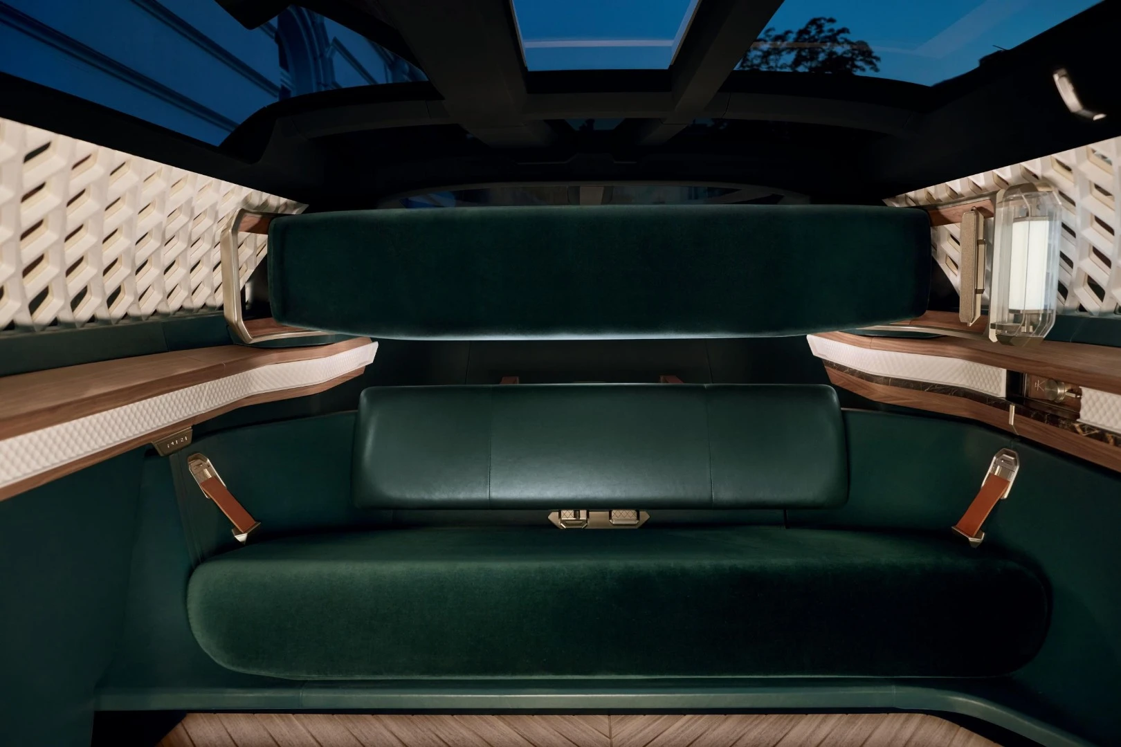 The interior features a two-seat bench on one end, a single chair on the other