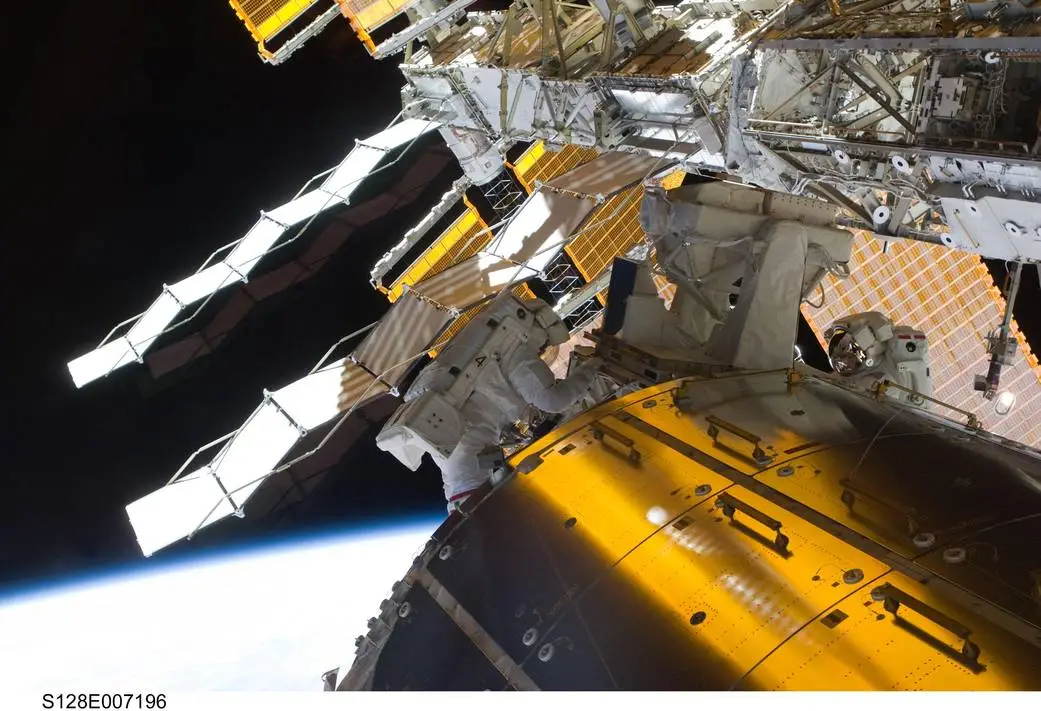 Astronauts Danny Olivas and Nicole Stott perform maintenance on the International Space Station