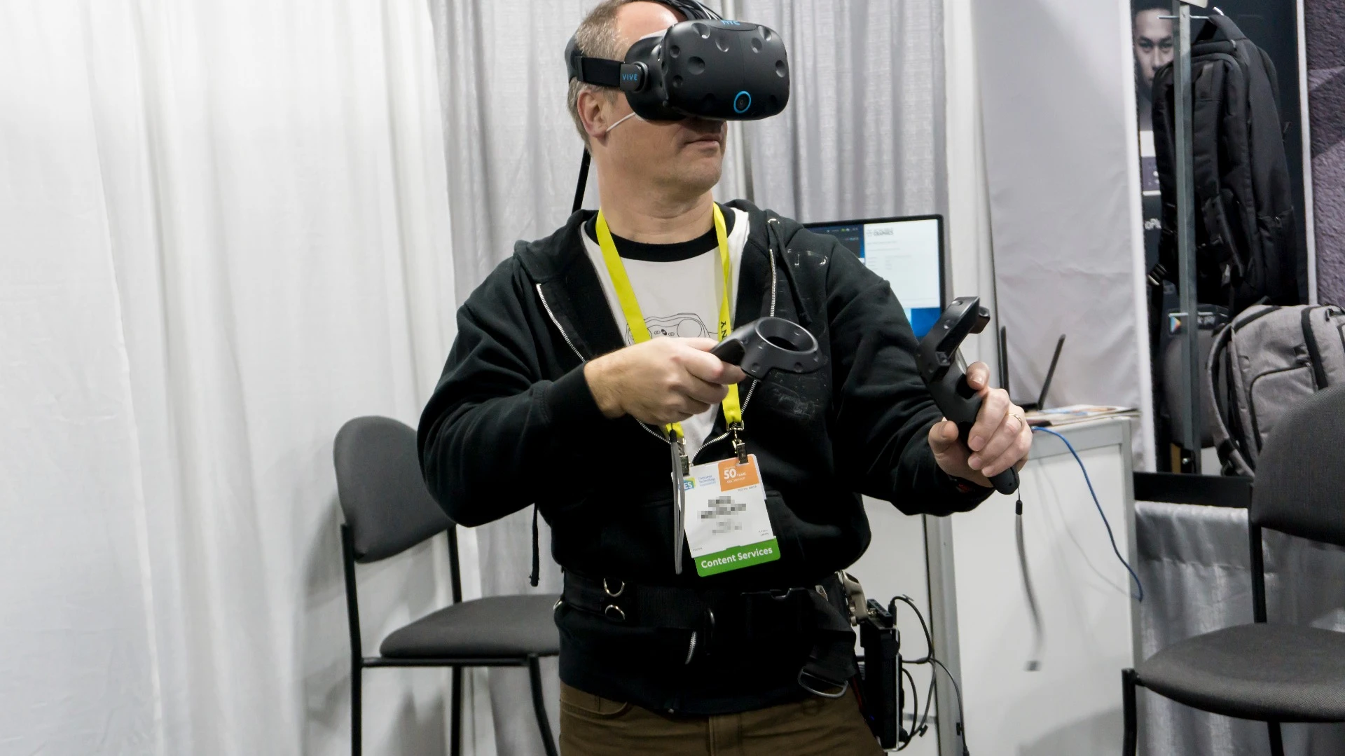 A CES attendee demoing KwikVR's wireless adapter for the HTC Vive and Oculus Rift