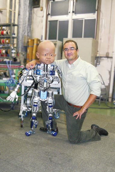 Dr. Javier Movellan, UCSD Machine Perception Lab, poses with an incomplete version of Diego-san at Kokoro Co. Ltd. in Japan