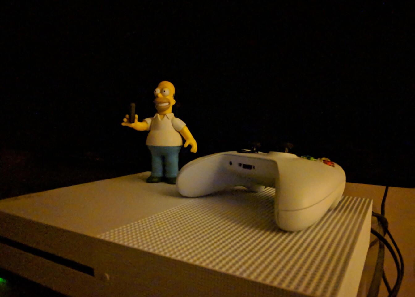 Turn on Night Sight on the Pixel 2, and the difference is extraordinary – sure, there's still a lot of noise here, but the model and controller are now fully visible and lit up