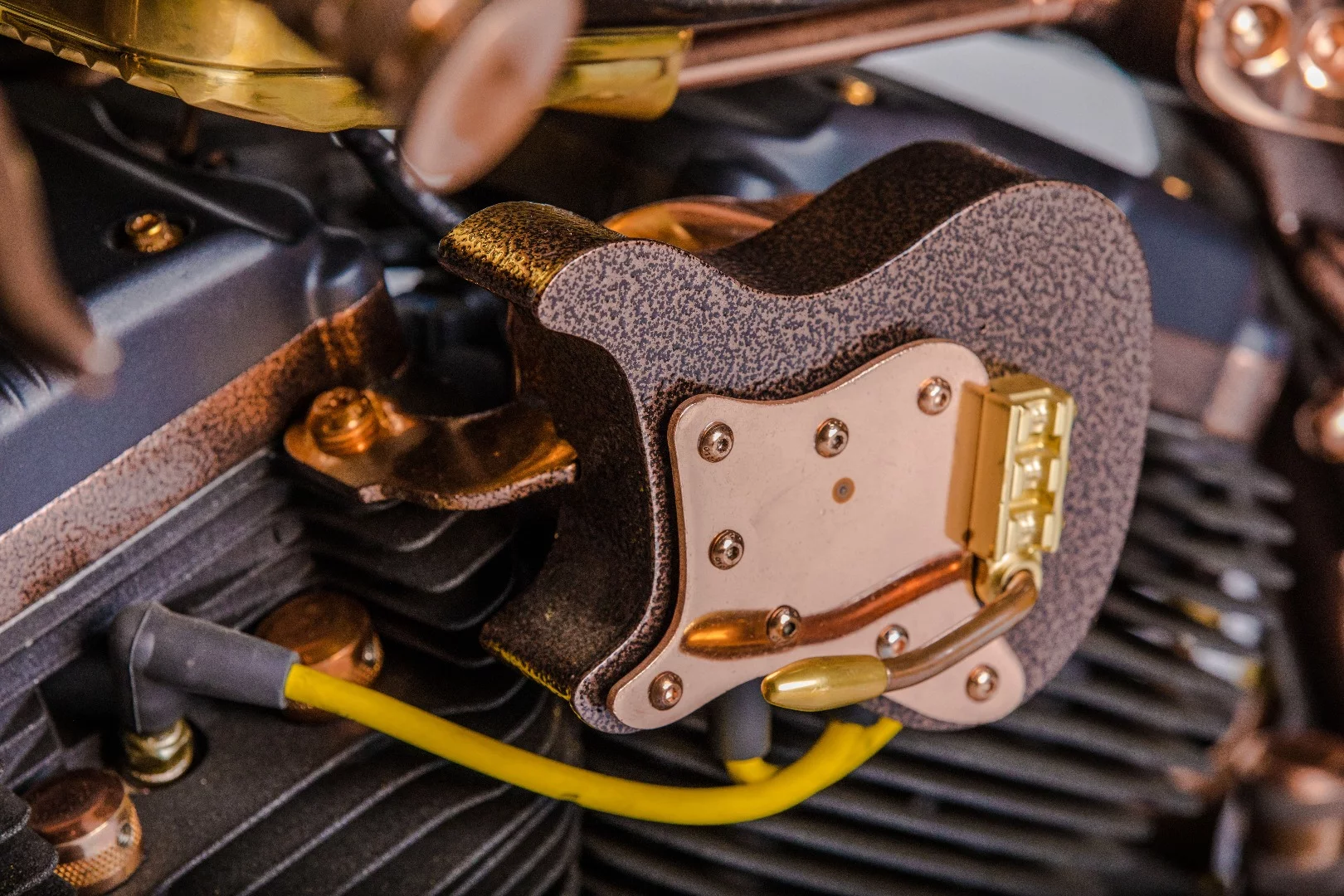 The guitar-shaped coil cover on the Cafe Racer by Game Over Cycles includes a tremolo arm for adjusting pressure