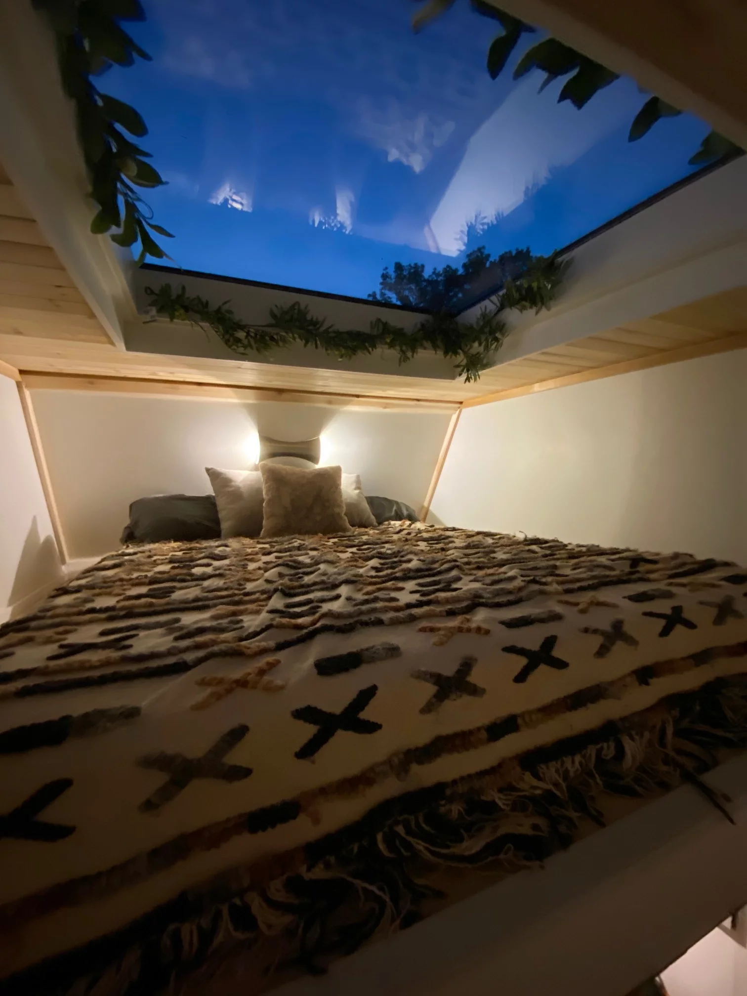 The elevated king-size loft bedroom features a 4 x 4-ft (1.22 x 1.22-m) tempered double paned skylight