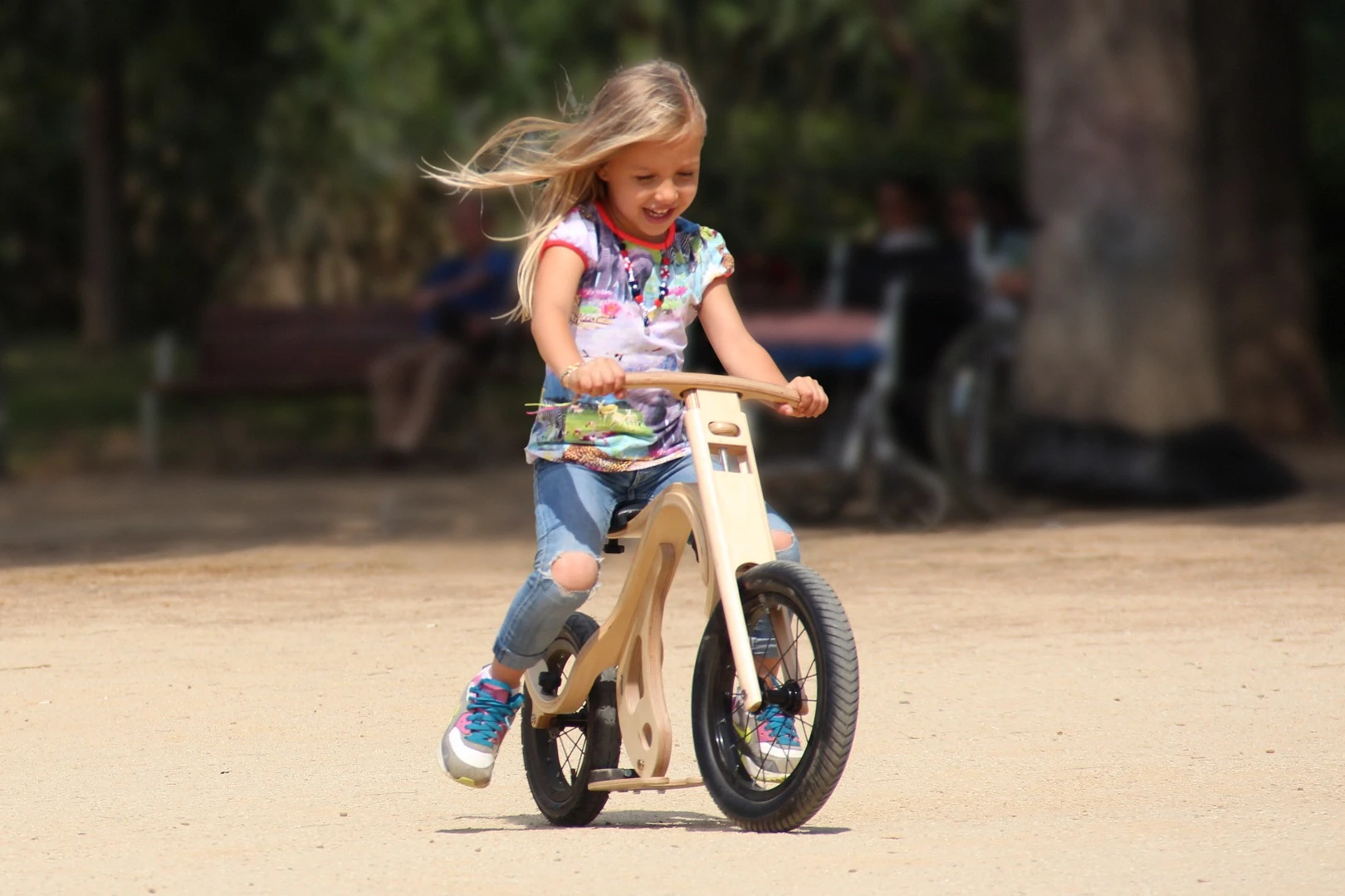 A young girl enjoys her Leg and Go downhill bike