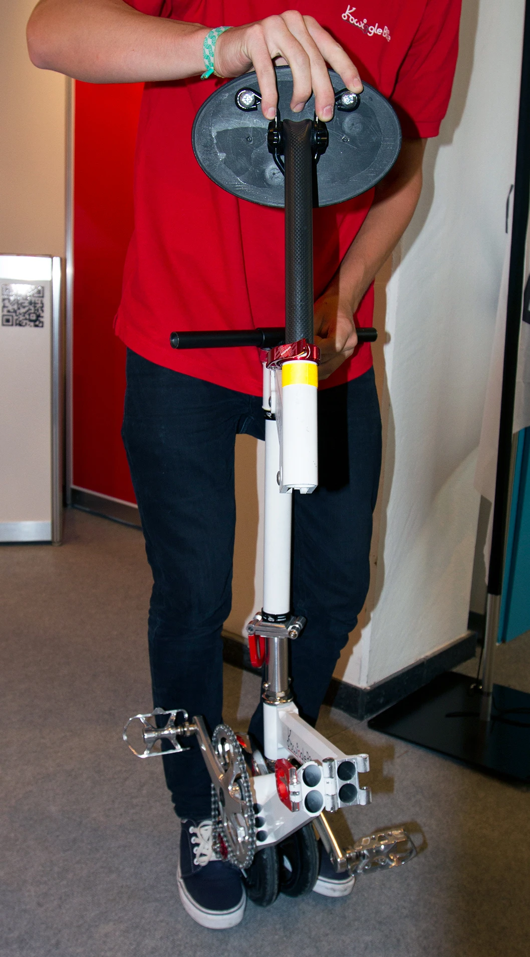The seat is folded over the handlebars