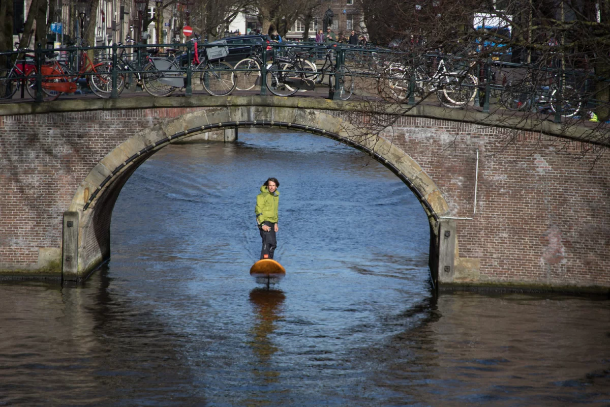 Inventor Don Montague rides his Jetfoiler board along Amsterdam's canals