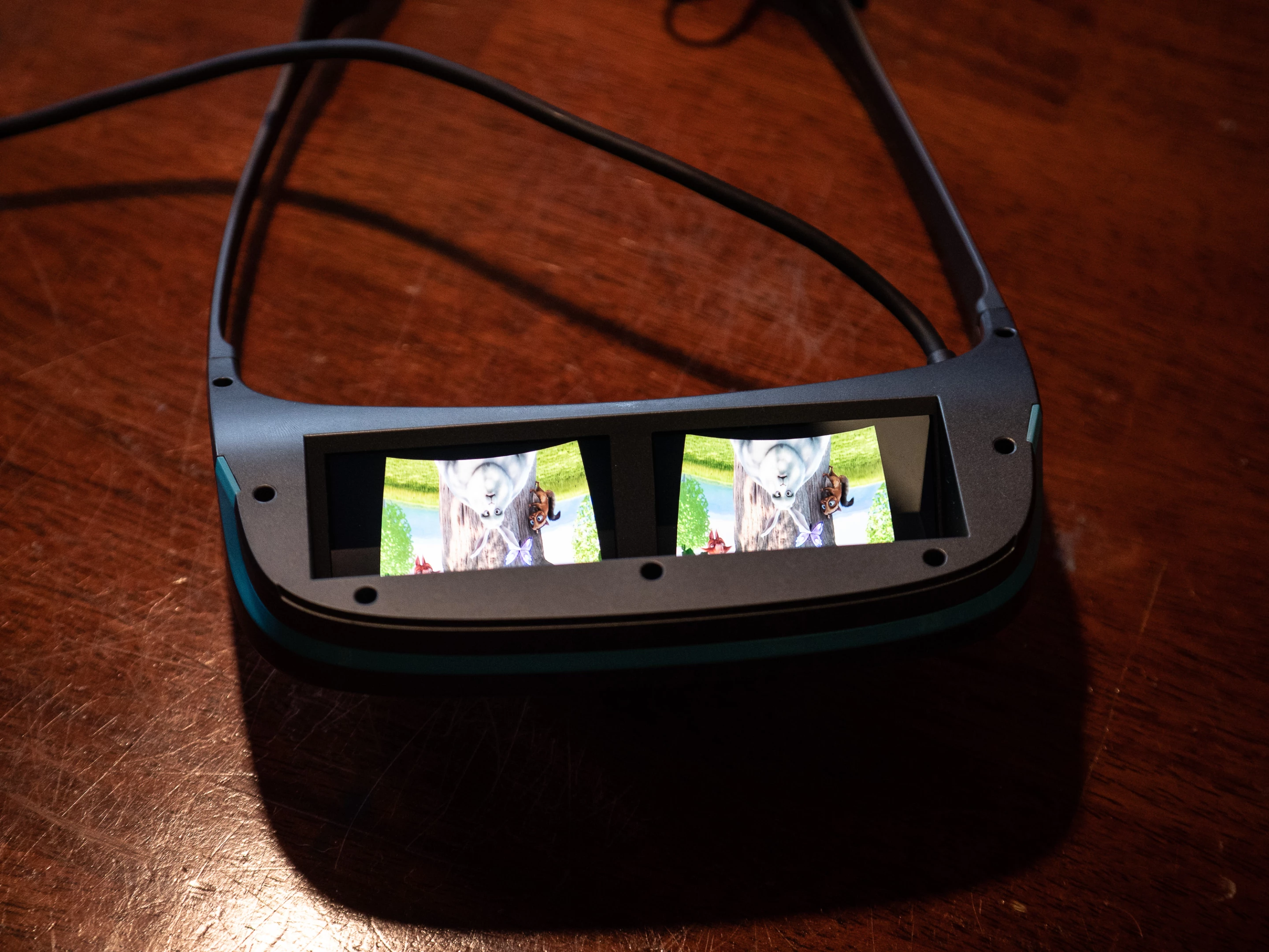 A miniature 1080p screen is reflected into each eye, giving a total 3840x1080 resolution and the ability to present content in 3D