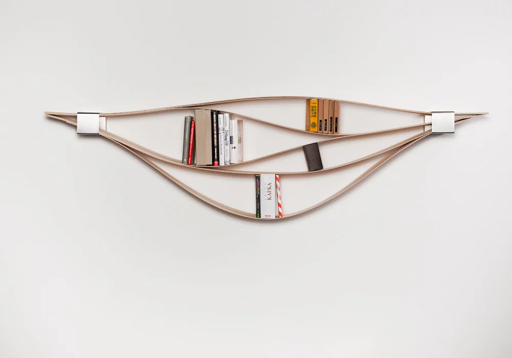 Chuck reveals itself when books and other objects are inserted between the flexible sheets of wood