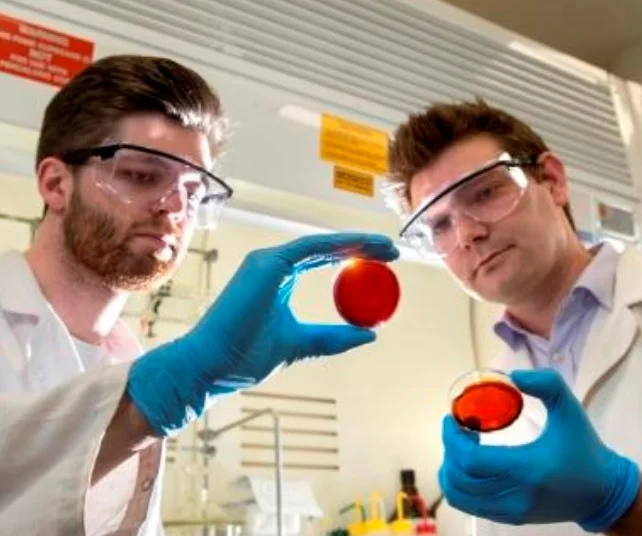 Flinders University student Max Worthington with Doctor Justin Chalker and samples of the new sulfur-limonene polymer