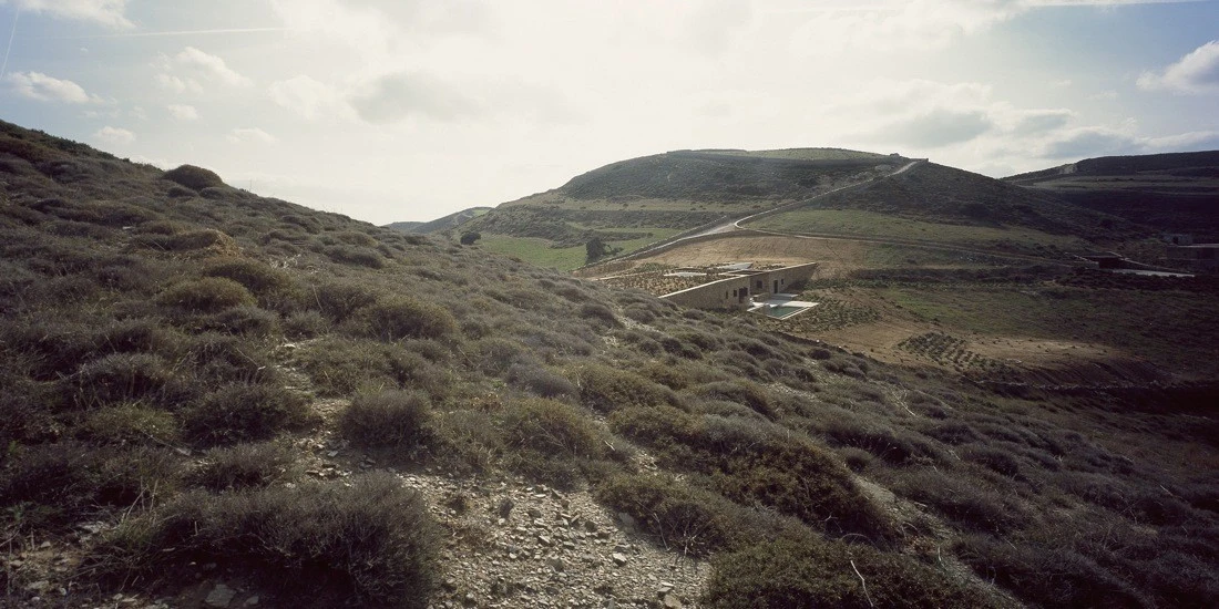 Aloni House sits in a natural gully between two sloping hills. Much of the structure nestles under the ground making it nearly impossible to grasp its true scale