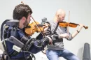 For the study, 20 pairs of violinists wore upper-body exoskeletons while performing together