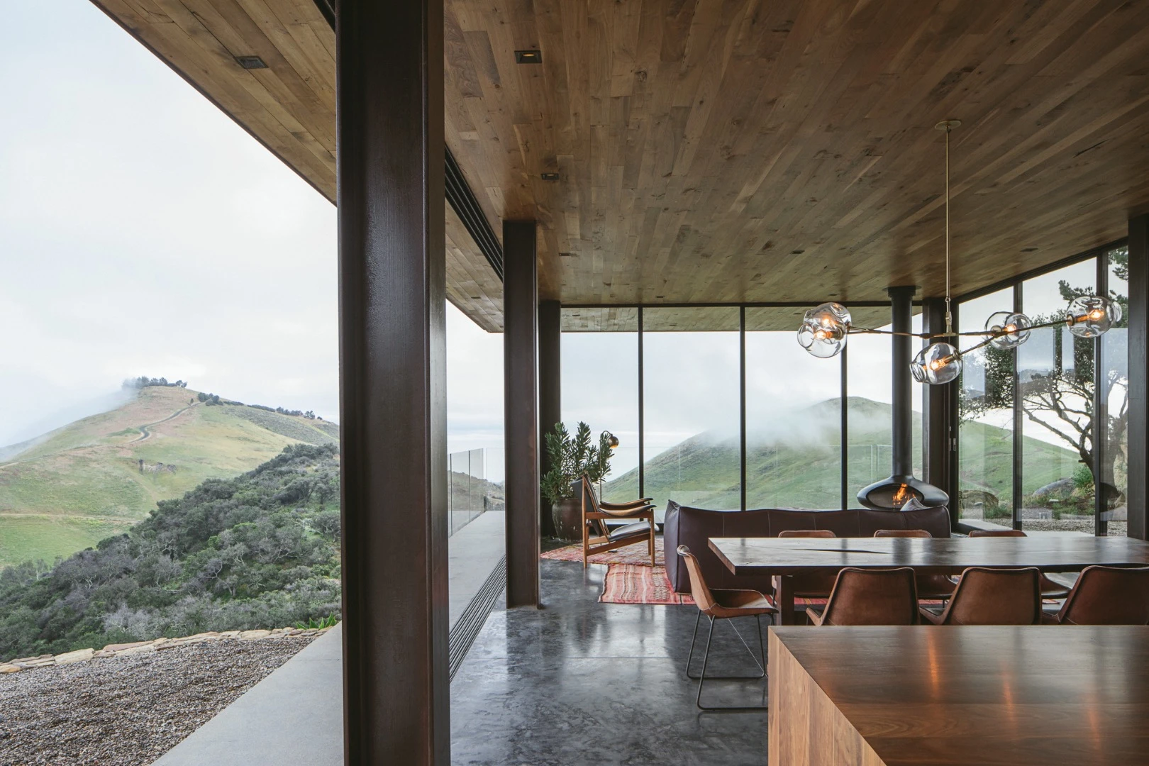 The Off-Grid Guest House's interior layout is centered around a generous living room that opens up to the outside